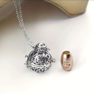 Silver Filigree Harmony Ball Necklace with Rose Gold Tone Urn